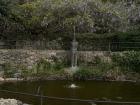 A fountain in a courtyard in the hillside of Florence. 