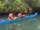 Riding a boat through a river, seeing amazing views (we jumped in the water after!)