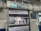 Inside of train, where a screen showing the destination is seen