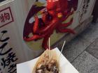 Eating takoyaki in Dotonbori, Osaka