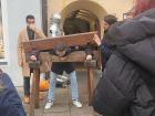 Friend tries the Pillory, a common wooden punishment that holds the persons arms and lead in, at the restaurant.