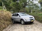 The poor state of roads makes access to rural neighborhoods difficult; here, our car got stuck in the mud on an unpaved road, and we had to push it out