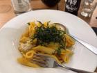 Pumpkin ragú pasta with sprout garnish