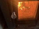 A wood-burning stove heats the sauna, keeping it nice and warm