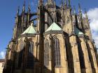 Looking up at the massive Gothic architecture on the back of St. Vitus Cathedral inside Prague Castle