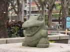 A photo of a crocodile statue in a park that I found nestled within a residential district