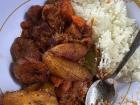 Rice with tomato stew, beef and plantain
