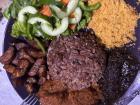 Waakye: beans and rice with a side of veggies, plantains, gari, sauce and shito