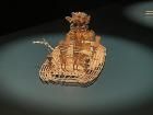Detailed gold statue titled "Mulsce Raft"