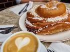 A giant cinnamon roll and coffee at a cafe in Gothenburg