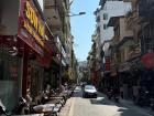 A typical street with sidewalks lined with motorbikes