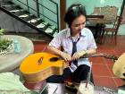 One of my students helping me replace my strings!