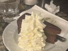 A Slice of Sachertorte with generous dollop of whipped cream at Vienna's Café Schwarzenberg 