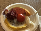 The white fruit on the spoon is guanábana (soursop)