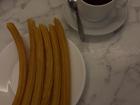 Freshly fried churros ready to be dipped in thick hot chocolate