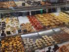 A bakery display filled with colorful Portuguese pastries