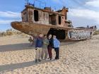 My friends and I standing in front of an abandoned fishing vessel 