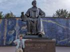 Standing with a statue of Ulugh Beg, in front of the ruins of his observatory