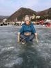 Riding a traditional Korean ice sled. 