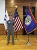 Parker pictured with the US, Peace Corps, and Belizean flags.